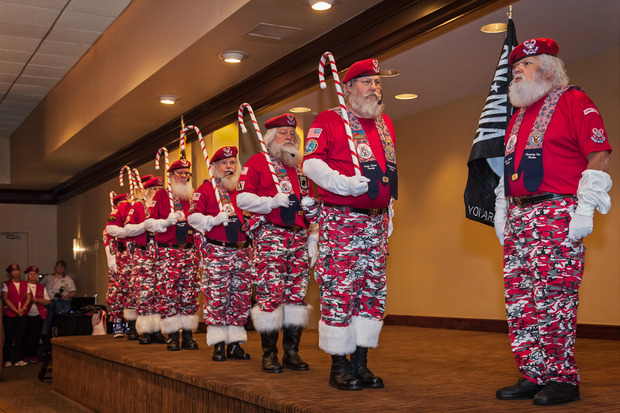 Line of Santa Clauses at military style attention
