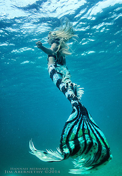 Hannah underwater in blue and black stripe tail