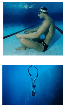 A man sitting underwater and another diving underwater with no tanks