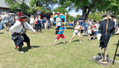 Mad Dog Mike in a tug-of-war with kids